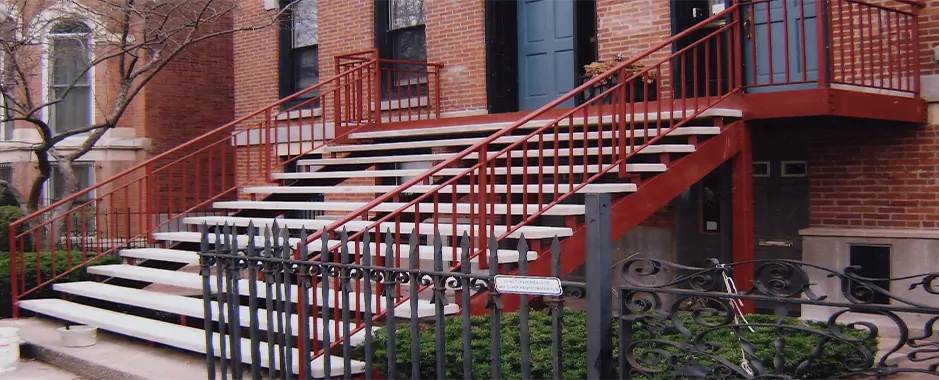 Large red steel railing and cement steps